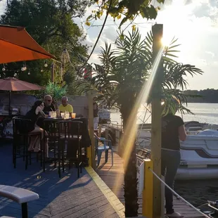 people sitting at tables on the dock