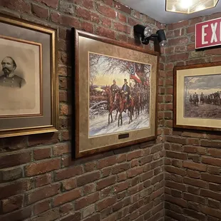 a brick wall with paintings on it