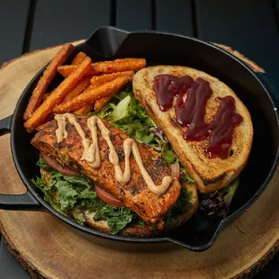 Three fluffy pancakes with cinnamon sugar dust. Served with fresh fruit, mint, and chocolate sauce with syrup.