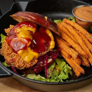 Crispy fried oyster mushrooms with vegan cheese, pickles, lettuce, tomato, spicy aioli (contains soy), and BBQ sauce on a pretzel bun.