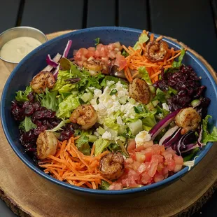 Spinach, Romaine, Avocado, Shredded Carrots, Cucumber, tomatoes, Feta cheese Shrimp, Cranberries.