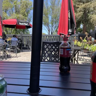 a bottle of soda and a can of soda on a table