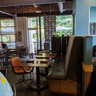 a dining area with tables and chairs