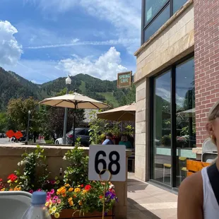 a woman sitting at a table outside