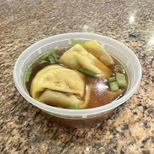 Won ton soup in a sauce container