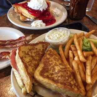 Monte Cristo with battered fries, and the stuffed French toast in the background with a side of bacon.