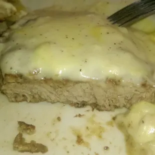 A close up look at the chicken fried steak, not frozen but only one piece of sausage in the grave.