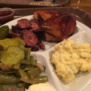 Black pepper sausage and chicken with potato salad and green beans.