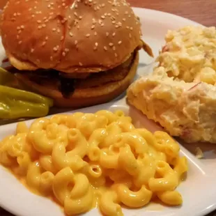 Pulled bbq pork sandwich with potato salad and mac and cheese