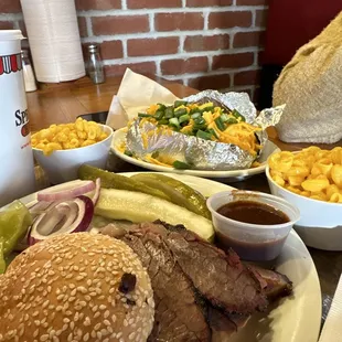 Brisket sandwich plate with baked potato and Mac and cheese