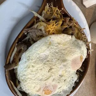 a plate of food with an egg and hash browns