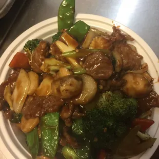 a plate of stir fried beef and broccoli