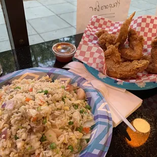 a plate of fried chicken and a bowl of fried rice