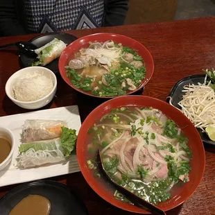 a bowl of soup, a bowl of rice, and a plate of salad