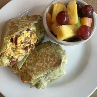 Breakfast Burrito with eggs peppers bacon and pepper jack cheese and fresh fruit.