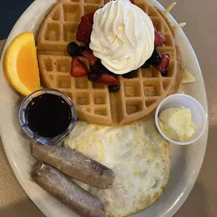 Waffle with fresh mixed berries and whipped cream, Apple Cinnamon sausage links and 2 eggs.