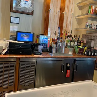 a bar with a sink and a television