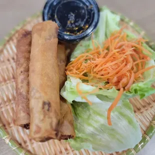 a plate of food with lettuce and carrots