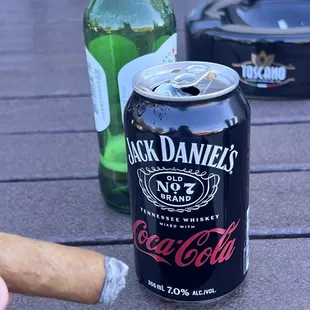 a can of jack daniels and a cigar