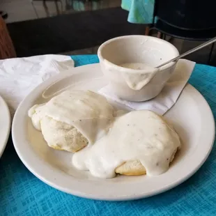 a plate of biscuits and a bowl of gravy
