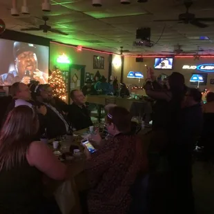 a large group of people sitting at a bar