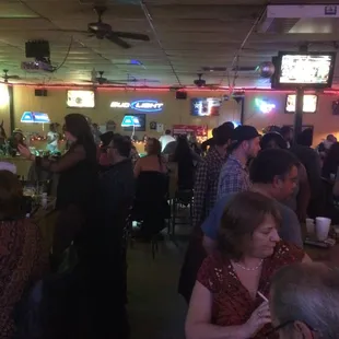 a large group of people sitting at a bar