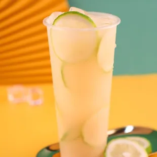 a glass of lemonade with ice cubes
