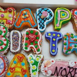 a box of decorated birthday cookies