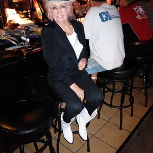 a woman sitting at a bar