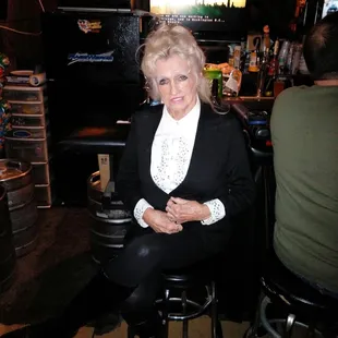 a woman sitting at a bar