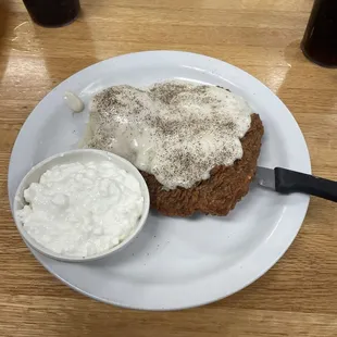 Chicken fried steak (dinner version) with mashed potatoes and cottage cheese.
