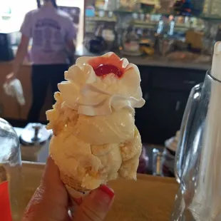 Double dip butter brickle w/ whipped cream &amp; a cherry in a sugar cone
