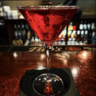 a red drink in a martini glass