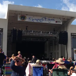 a crowd of people sitting in lawn chairs