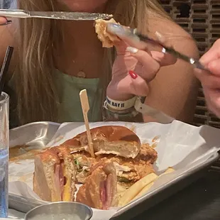 Half of a spicy chicken sandwich and half of a Monte Cristo