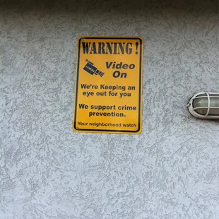 a warning sign on the side of a building