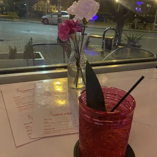 a glass with a flower in it
