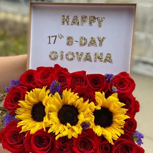 a woman holding a bouquet of sunflowers