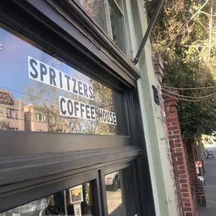 the reflection of a sign in a window