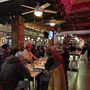 people sitting at tables in a restaurant