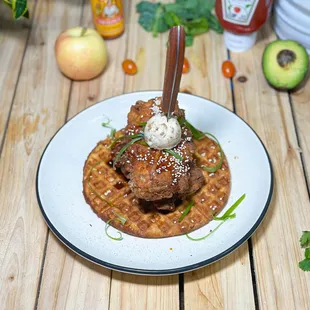 K- Bomb Chicken and Waffle.

Belgian waffles, pecan praline butter, Korean fried chicken breast, maple-gochujang syrup.