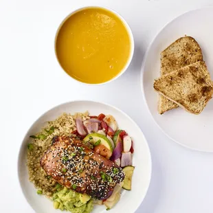 Homemade vegan pumpkin soup and baked salmon protein bowl.