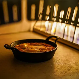 a pan of food in front of a window