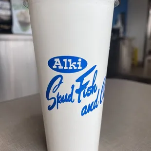 a white cup with blue lettering