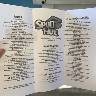 a hand holding a menu
