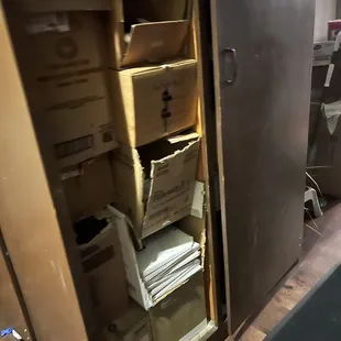 Broken cabinets with exposed supplies... this is what you pass through to get to the bathroom