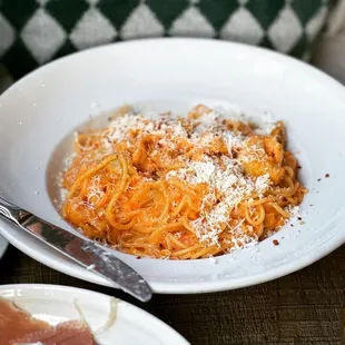 a plate of pasta with meat and cheese