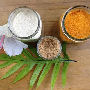 three jars of sugar and a flower