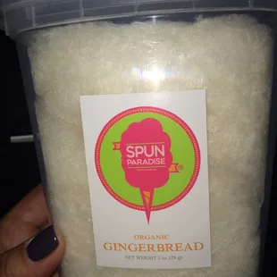 a hand holding a tub of organic gingerbread