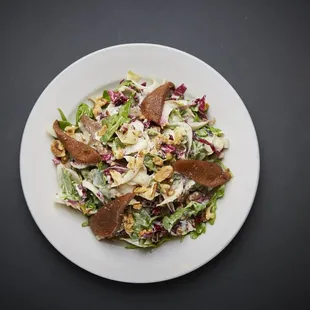 a white plate with a salad on it
